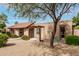 Side view of a single-story home with desert landscaping and a red front door at 3255 E Malapai Dr, Phoenix, AZ 85028