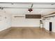 Spacious garage with storage cabinets, a Tesla battery, and epoxy floors at 3255 E Malapai Dr, Phoenix, AZ 85028