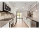 Well-equipped kitchen featuring stainless steel appliances and access to outdoor pool at 3255 E Malapai Dr, Phoenix, AZ 85028