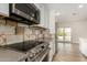 Modern kitchen featuring stainless steel appliances and decorative backsplash at 3255 E Malapai Dr, Phoenix, AZ 85028