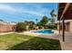 A refreshing pool surrounded by lush greenery and a privacy fence at 3255 E Malapai Dr, Phoenix, AZ 85028