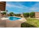 Backyard pool with clear blue water, surrounded by well-manicured landscaping at 3255 E Malapai Dr, Phoenix, AZ 85028