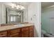 Bathroom featuring wood vanity with granite counter, a large mirror, and a shower at 3500 N Hayden Rd # 1603, Scottsdale, AZ 85251