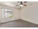 This carpeted bedroom has a window providing natural light and a ceiling fan for climate control at 3500 N Hayden Rd # 1603, Scottsdale, AZ 85251