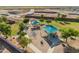 Aerial view showcasing the playgrounds, park, and green spaces within the community at 38115 W Excussare Way, Maricopa, AZ 85138