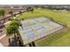 Aerial view showcasing the community's park with pickleball and basketball courts at 38115 W Excussare Way, Maricopa, AZ 85138
