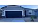 Charming single-Gathering home featuring a modern garage door and manicured landscaping at 38115 W Excussare Way, Maricopa, AZ 85138