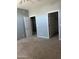 Spacious bedroom featuring neutral carpeting and multiple doorways for easy access at 4151 E Campbell Ave, Gilbert, AZ 85234