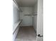 Bright walk-in closet with shelving and wood rods for clothing storage at 4151 E Campbell Ave, Gilbert, AZ 85234