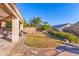 Spacious backyard featuring a lush lawn, mature trees, and a covered patio at 4611 E Red Bird Rd, Cave Creek, AZ 85331