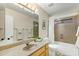 Bright bathroom with a shower-tub combo, a light wood vanity, and a large mirror at 4611 E Red Bird Rd, Cave Creek, AZ 85331