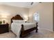 Bright bedroom with a wooden bed frame, bedside tables with lamps, neutral walls, and carpeted floors at 4611 E Red Bird Rd, Cave Creek, AZ 85331