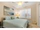 Cozy bedroom featuring a queen bed, ceiling fan, shuttered windows, and neutral walls at 4611 E Red Bird Rd, Cave Creek, AZ 85331