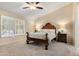 Cozy bedroom with a wooden bed frame, neutral walls, carpeted floors, and lots of natural light at 4611 E Red Bird Rd, Cave Creek, AZ 85331