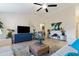 Bright living room featuring a ceiling fan, tile flooring, modern decor, and comfortable seating at 4611 E Red Bird Rd, Cave Creek, AZ 85331