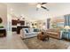 Spacious living room featuring tile floors, ceiling fan, and an open layout that connects to the kitchen at 4611 E Red Bird Rd, Cave Creek, AZ 85331