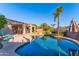 Backyard with a sparkling pool, lush landscaping, and an inviting covered patio at 4611 E Red Bird Rd, Cave Creek, AZ 85331