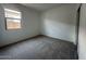 Cozy bedroom with soft carpet, a large window, and neutral decor at 46922 W Coe St, Maricopa, AZ 85139