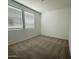 Bright bedroom with plush carpeting and large windows for natural light at 46922 W Coe St, Maricopa, AZ 85139