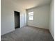Inviting bedroom features plush carpeting for warmth, with ample natural light and a cozy ambiance at 46922 W Coe St, Maricopa, AZ 85139