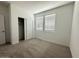 Clean, carpeted bedroom with a closet and well-lit by two windows at 46922 W Coe St, Maricopa, AZ 85139