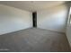 Bright bedroom featuring neutral carpeting, and blank canvas walls for flexible decor at 46922 W Coe St, Maricopa, AZ 85139