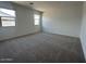 Spacious bedroom with plush carpeting, lots of natural light, and neutral color palette at 46922 W Coe St, Maricopa, AZ 85139