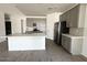 Open kitchen featuring a large island, modern appliances, and stylish gray cabinetry at 46922 W Coe St, Maricopa, AZ 85139