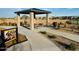 Community covered picnic area near the playground with seating, sidewalks, and landscaping at 46922 W Coe St, Maricopa, AZ 85139