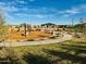 Community playground with play equipment, covered seating, sidewalks, and landscaping at 46922 W Coe St, Maricopa, AZ 85139