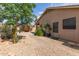 Cozy backyard with brick pathway, gravel landscaping and mature trees, providing a tranquil outdoor retreat at 5336 W Campo Bello Dr, Glendale, AZ 85308
