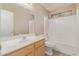 Bright bathroom with a single sink vanity, window and tub shower combination at 5336 W Campo Bello Dr, Glendale, AZ 85308