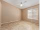 Carpeted bedroom with a ceiling fan, a window and electrical outlets at 5336 W Campo Bello Dr, Glendale, AZ 85308