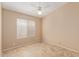 Bedroom features tile floor, a ceiling fan, and a bright window at 5336 W Campo Bello Dr, Glendale, AZ 85308