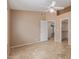 Neutral bedroom featuring a ceiling fan, tile floors, and entry to walk-in closet at 5336 W Campo Bello Dr, Glendale, AZ 85308