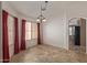 Bright dining area with tiled floors, and large windows framed by bold curtains at 5336 W Campo Bello Dr, Glendale, AZ 85308
