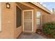 Welcoming front porch featuring a secure screen door, natural light, and vibrant red flowers at 5336 W Campo Bello Dr, Glendale, AZ 85308