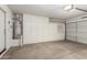 Attached garage with built in storage cabinets and hot water heater at 5336 W Campo Bello Dr, Glendale, AZ 85308