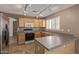 Bright kitchen featuring track lighting, tile floors, stainless steel refrigerator and light wood cabinetry at 5336 W Campo Bello Dr, Glendale, AZ 85308