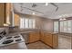 Bright kitchen featuring track lighting, tile floors, stainless steel dishwasher and light wood cabinetry at 5336 W Campo Bello Dr, Glendale, AZ 85308