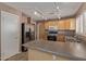 Well-lit kitchen featuring stainless steel appliances, track lighting, and a breakfast bar at 5336 W Campo Bello Dr, Glendale, AZ 85308