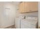 Laundry room features washer, dryer, storage cabinets and hanging hooks at 5336 W Campo Bello Dr, Glendale, AZ 85308