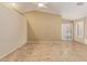 Spacious living room with vaulted ceiling, tiled floors, and sliding glass doors at 5336 W Campo Bello Dr, Glendale, AZ 85308