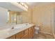 The main bathroom features a double sink vanity, a glass enclosed shower and a toilet at 5336 W Campo Bello Dr, Glendale, AZ 85308
