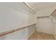 Walk-in closet features wooden shelving and tile flooring, providing ample storage space at 5336 W Campo Bello Dr, Glendale, AZ 85308