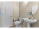 Cozy half bath featuring a pedestal sink, neutral colors, and classic fixtures at 5415 E Mckellips Rd # 100, Mesa, AZ 85215