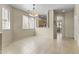 Bright dining area featuring tile floors, a modern light fixture, and an open layout to the kitchen at 5415 E Mckellips Rd # 100, Mesa, AZ 85215