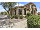 Charming home exterior featuring a tiled roof, manicured landscaping, and a welcoming front yard at 5415 E Mckellips Rd # 100, Mesa, AZ 85215