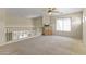 This loft features neutral walls and carpeting, a ceiling fan, and a built-in cabinet with television at 5415 E Mckellips Rd # 100, Mesa, AZ 85215