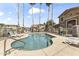 Community pool area with inviting turquoise water, tall palm trees, and several lounge chairs around the pool at 5415 E Mckellips Rd # 100, Mesa, AZ 85215